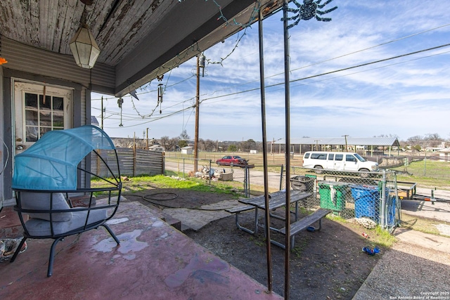 view of patio featuring fence