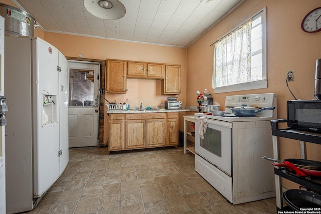 kitchen with white appliances, stone finish flooring, and light countertops