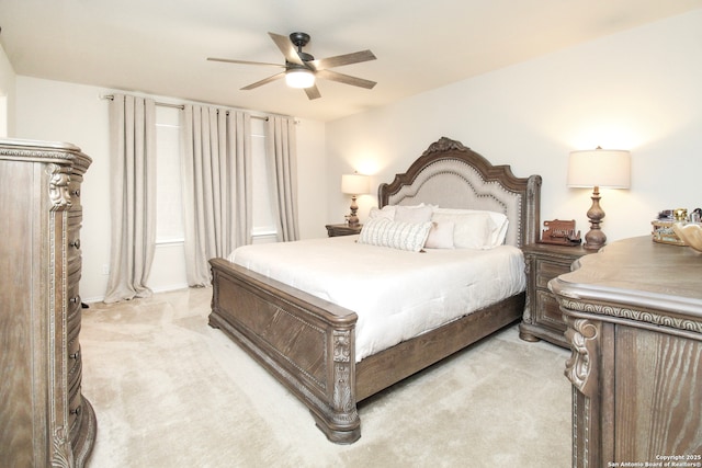 bedroom with ceiling fan and light colored carpet