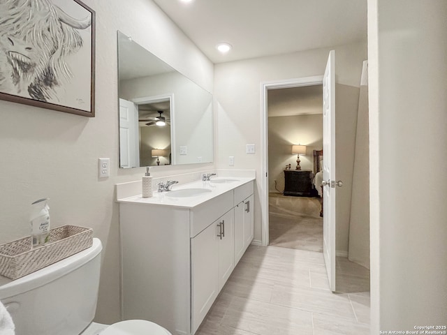 ensuite bathroom featuring a sink, toilet, and ensuite bathroom