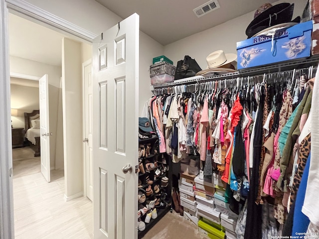 walk in closet featuring wood finished floors and visible vents