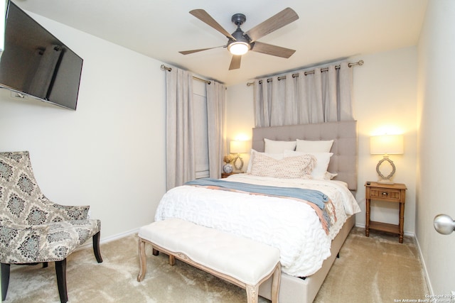 bedroom with light carpet, ceiling fan, and baseboards