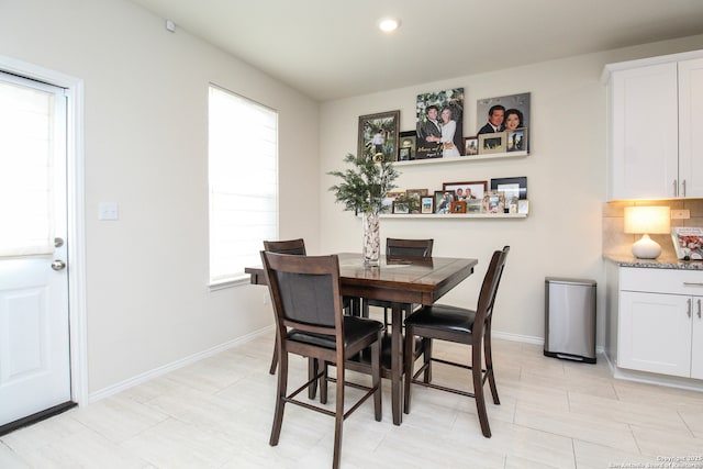 dining area with baseboards and recessed lighting