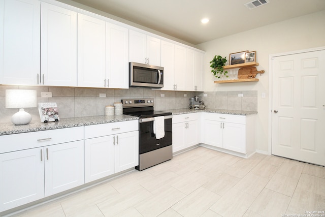 kitchen featuring open shelves, appliances with stainless steel finishes, backsplash, and white cabinetry