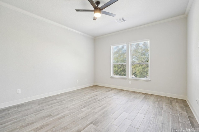 spare room featuring light wood-style flooring, visible vents, ornamental molding, and a ceiling fan