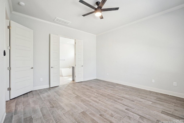 unfurnished bedroom with ornamental molding, light wood finished floors, and visible vents