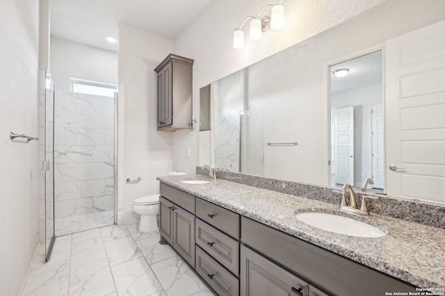 bathroom featuring toilet, a sink, marble finish floor, a marble finish shower, and double vanity