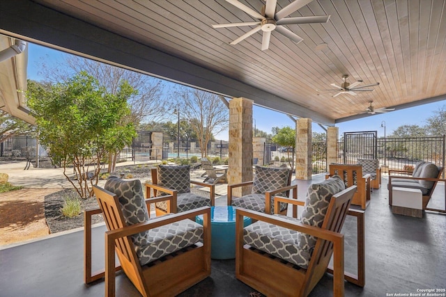 view of patio / terrace with an outdoor living space, fence, and a ceiling fan