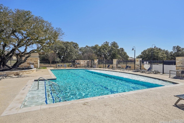 pool featuring a patio and fence