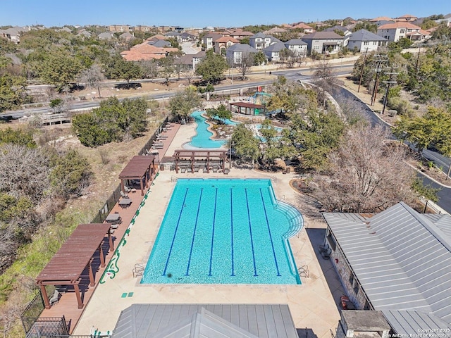 pool featuring a patio and a residential view