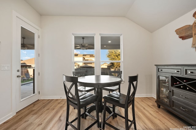 dining area with plenty of natural light, vaulted ceiling, and light wood finished floors