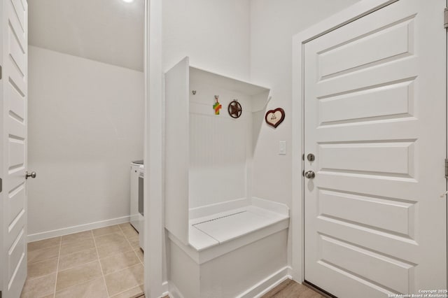 mudroom featuring light tile patterned flooring and baseboards