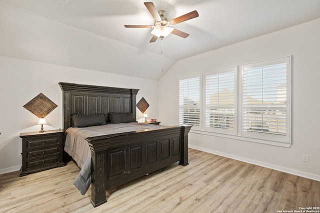 bedroom with lofted ceiling, light wood-style flooring, baseboards, and a ceiling fan