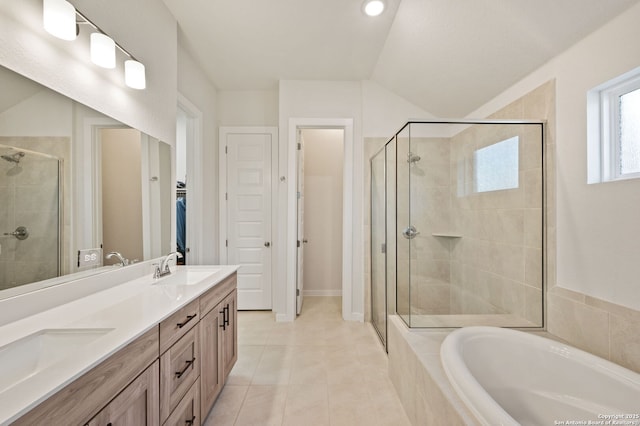 bathroom featuring double vanity, a stall shower, tile patterned flooring, a walk in closet, and a bath