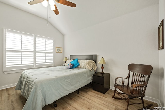 bedroom with lofted ceiling, a ceiling fan, light wood-style flooring, and baseboards