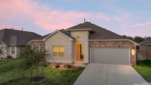 view of front of home featuring concrete driveway, a shingled roof, an attached garage, and a front yard