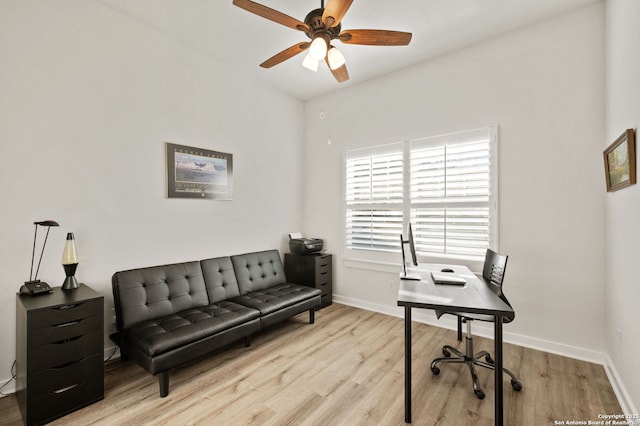 office featuring baseboards, a ceiling fan, and light wood-style floors