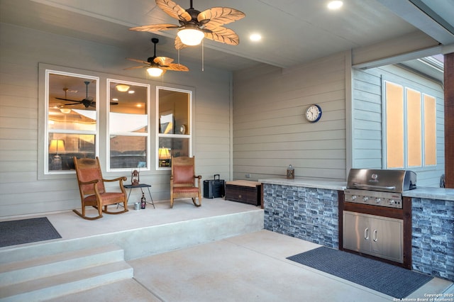 view of patio featuring ceiling fan, grilling area, and an outdoor kitchen