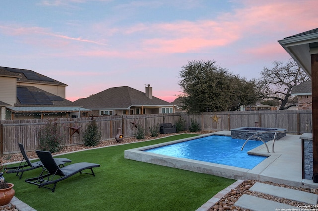 pool at dusk with an in ground hot tub, a lawn, a fenced backyard, and a fenced in pool