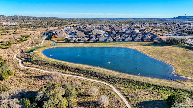 drone / aerial view featuring a residential view and a water view