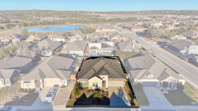 birds eye view of property with a water view and a residential view