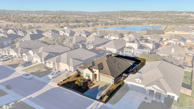 bird's eye view with a residential view and a water view