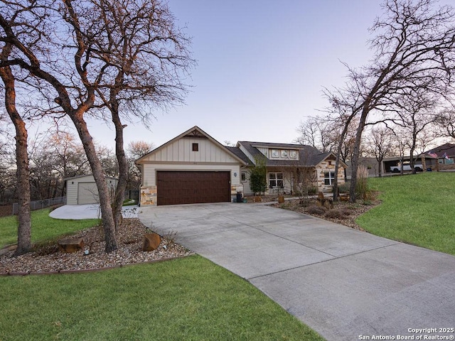 view of front of home featuring a garage, driveway, stone siding, board and batten siding, and a front yard