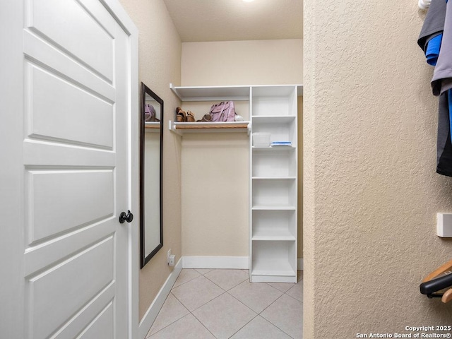 spacious closet with light tile patterned floors