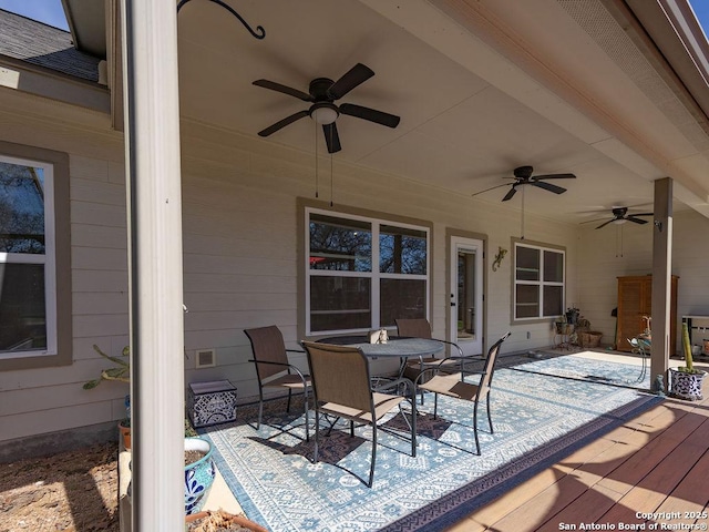 wooden terrace featuring a patio and outdoor dining space