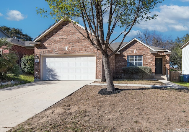 single story home featuring a garage, concrete driveway, and brick siding