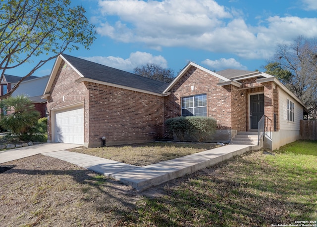 ranch-style home featuring a front lawn, concrete driveway, brick siding, and an attached garage