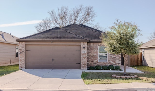 single story home featuring a garage, driveway, and brick siding