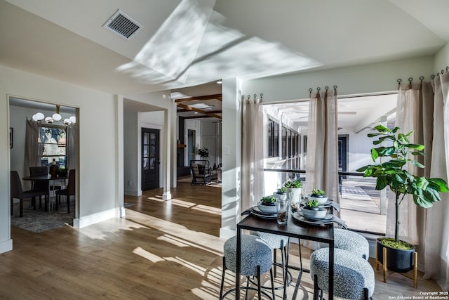 interior space featuring wood finished floors, visible vents, and baseboards