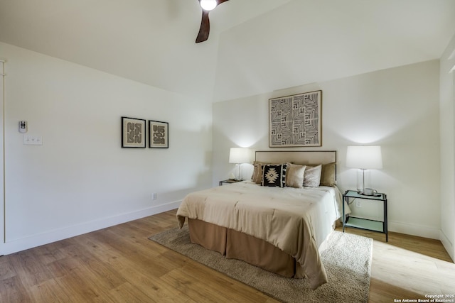 bedroom with high vaulted ceiling, baseboards, ceiling fan, and light wood finished floors