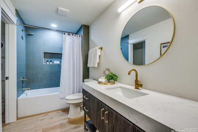 full bath featuring toilet, shower / tub combo, wood finished floors, and vanity