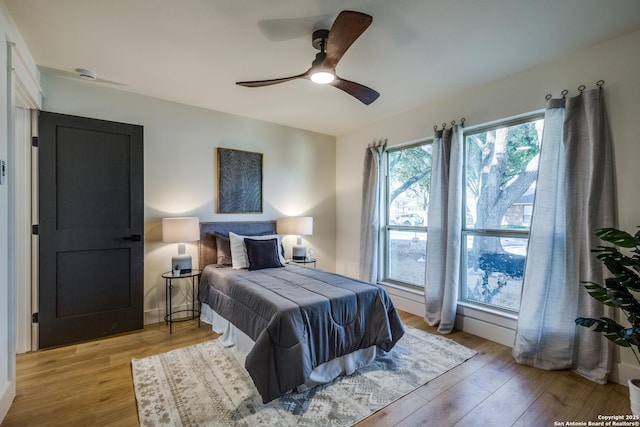 bedroom with light wood finished floors and a ceiling fan