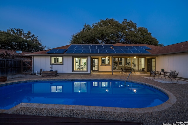 view of swimming pool with a fenced in pool, outdoor dining space, a patio, and fence