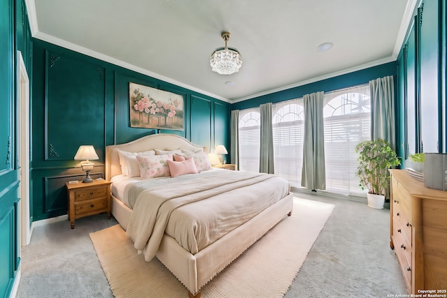 bedroom featuring crown molding, light colored carpet, and a decorative wall