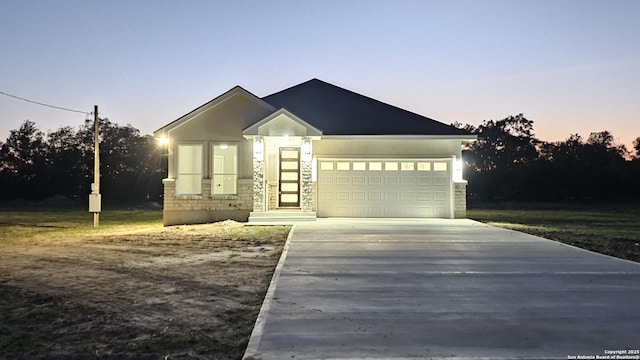 16107 Vaquero Dr, Atascosa, TX 78002 - ranch-style home with concrete driveway, stone siding, and a garage
