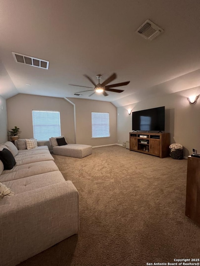 carpeted living room with lofted ceiling, visible vents, and a ceiling fan