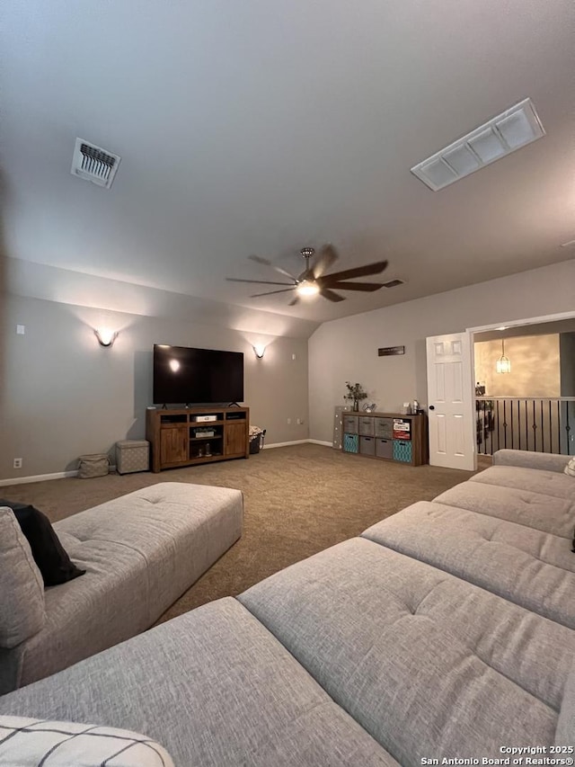 carpeted living area with lofted ceiling, ceiling fan, visible vents, and baseboards