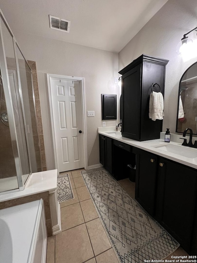 full bathroom featuring tile patterned flooring, visible vents, a sink, and double vanity