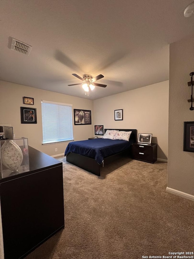 carpeted bedroom with visible vents, ceiling fan, and baseboards