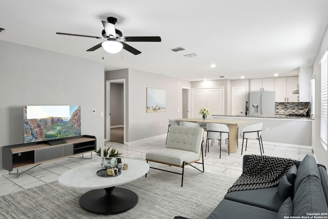 living room with baseboards, visible vents, ceiling fan, marble finish floor, and recessed lighting