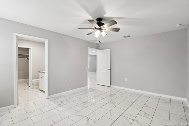 unfurnished bedroom with marble finish floor and baseboards