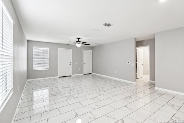 unfurnished room featuring marble finish floor, visible vents, ceiling fan, and baseboards