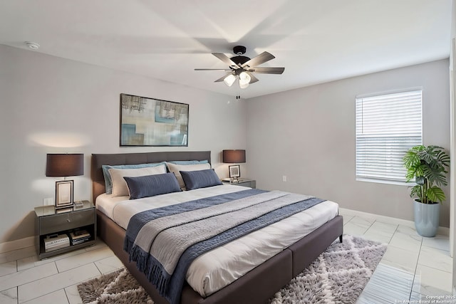 bedroom featuring a ceiling fan and baseboards