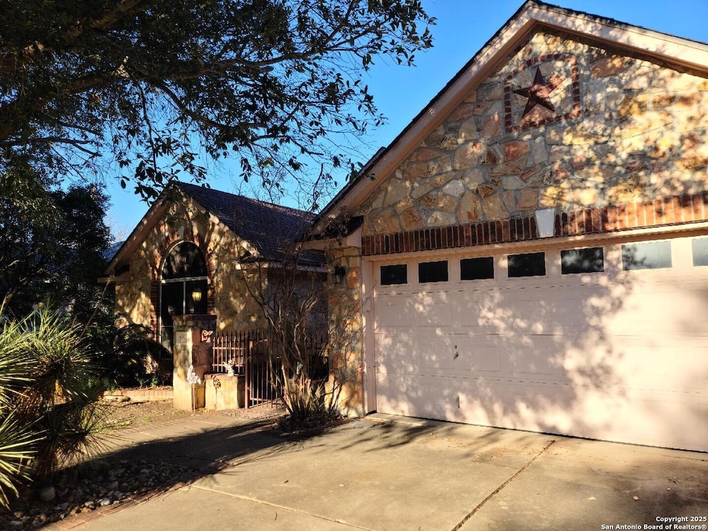 view of side of property with concrete driveway and an outbuilding