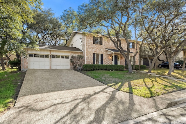 view of front facade with a garage, concrete driveway, brick siding, and a front yard