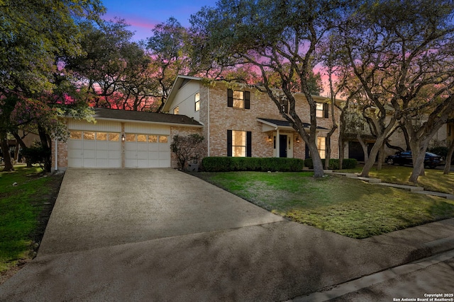 view of front facade with an attached garage, brick siding, concrete driveway, and a front yard